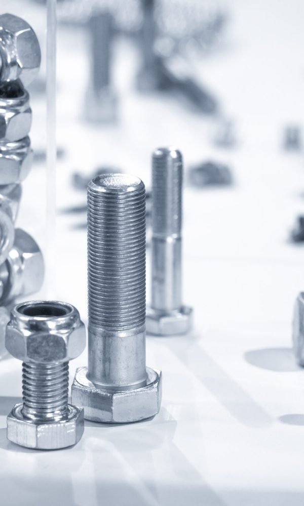 blue toned industrial nuts and bolts close-up